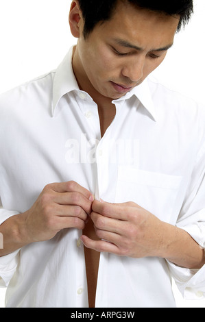 Man Buttoning Up Shirt Stock Photo