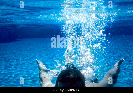 Man seen from underwater in swimming pool Stock Photo