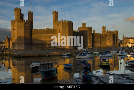 Sunset over Caernarfon Castle Caernarfon Gwynedd North Wales Stock Photo