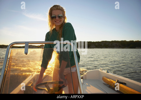 Young Woman in speedboat Stock Photo