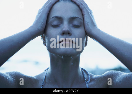 Young Woman in rain wearing bikini