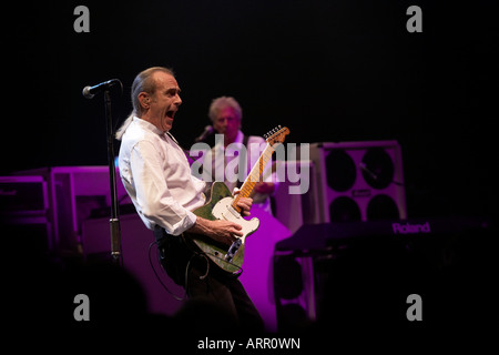 Francis Rossi and musician John Rhino Edwards of rock band Status Quo play guitar during gig on European tour in France Stock Photo