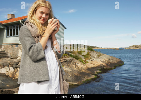 Young Woman drinking Coffee or Tea Stock Photo