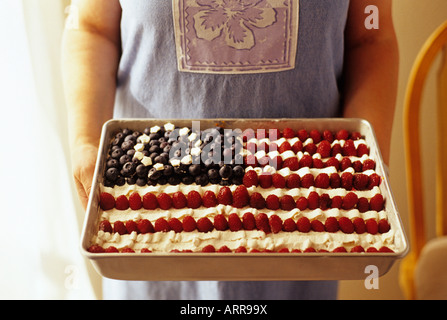 Woman holding an American flag cake on the 4th of July Independence Day for America Stock Photo