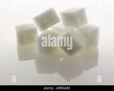 White refined Sugar cubes  against a white background Stock Photo