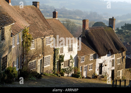 Gold Hill made famous by Hovis Advertisement in Shaftesbury Dorset England Edge of Town Housing Wintertime landscape Stock Photo