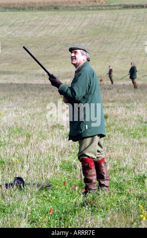 holding a shotgun a sydicate member waits for the game to appear Stock Photo