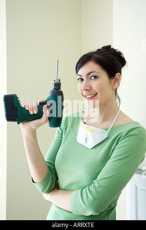 Woman with a power drill Stock Photo