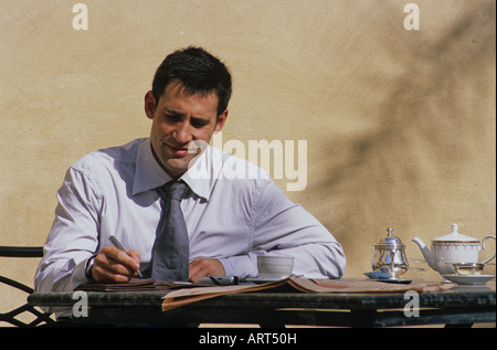 Businessman making notes in his diary Stock Photo