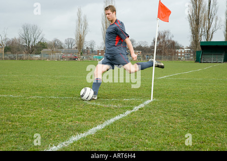 Footballer taking a corner kick Stock Photo