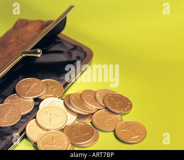 Coins falling into a purse Stock Photo - Alamy
