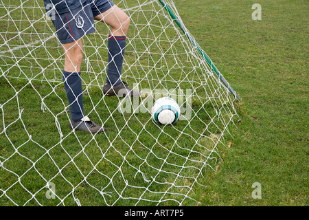 Footballer in goal with football Stock Photo