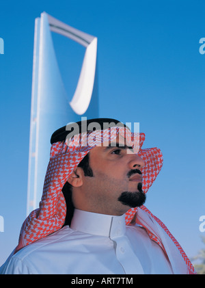Saudi Businessman outside Al Mamlakah (Kingdom) Tower in Riyadh, Saudi Arabia Stock Photo