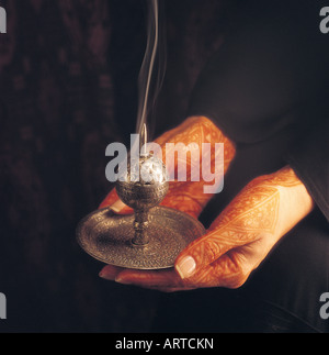 Arab woman holding incense burner Stock Photo