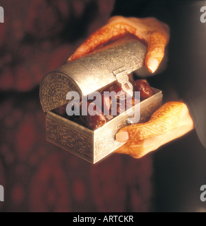 Ramadan: Arab woman holding a box with dried dates Stock Photo