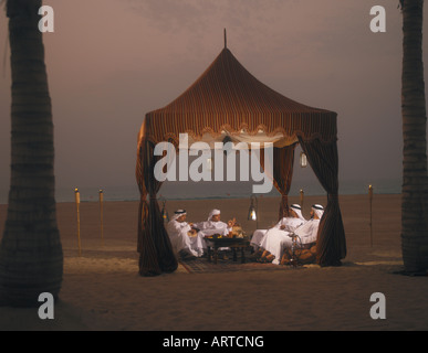 Ramadan: men sitting in Arabian tent for Iftar (fast-breaking meal after sunset) Stock Photo