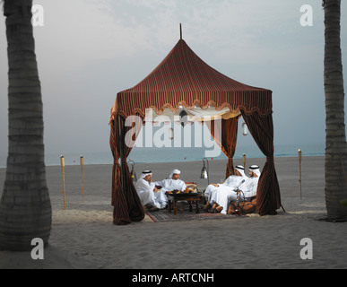 Ramadan: Arab men sitting in Arabian tent for Iftar (fast-breaking meal after sunset) Stock Photo