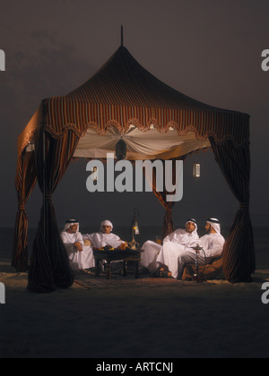 Ramadan: Arab men sitting in Arabian tent for Iftar (fast-breaking meal after sunset) Stock Photo