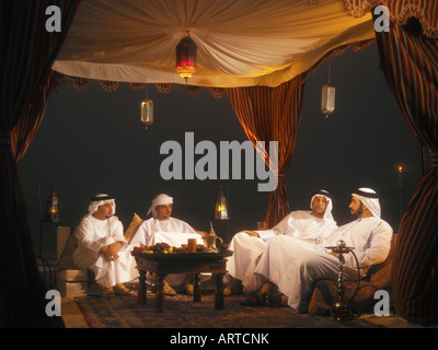 Ramadan: men sitting in Arabian tent for Iftar (fast-breaking meal after sunset) Stock Photo