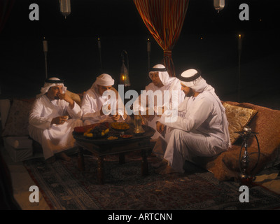 Ramadan: men sitting in Arabian tent for Iftar (fast-breaking meal after sunset) Stock Photo