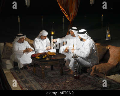Ramadan: Arab men sitting in Arabian tent for Iftar (fast-breaking meal after sunset) Stock Photo