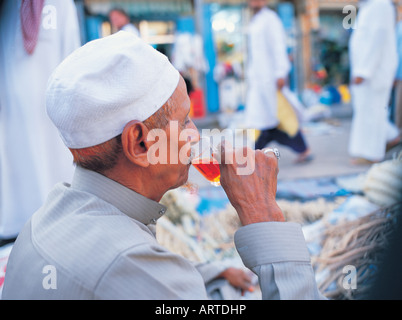 Old Merchant drinking tea in Bab Makkah, Jeddah, Saudi Arabia Stock Photo