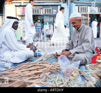 Old Merchant selling Miswak (twigs to clean mouth and teeth - Islamic tradition) in Bab Makkah, Jeddah, Saudi Arabia Stock Photo
