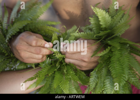 Male (kane) hula dancer deep in thought, wearing palapalai fern head lei, headshot. Stock Photo