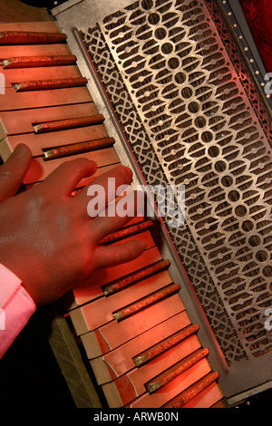 A creepy false hand plays an old Accordion. Stock Photo