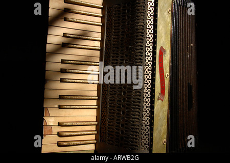 An old broken Accordion in the shadows. Stock Photo