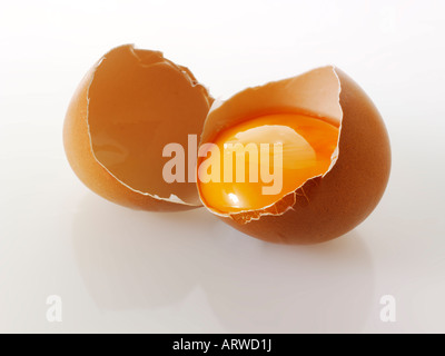 Organic  Burford brown egg cracked in half showing yolk Stock Photo