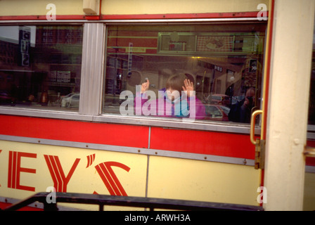 Girl age 5 looking out of famous Mickey's Restaurant window. St Paul Minnesota USA Stock Photo