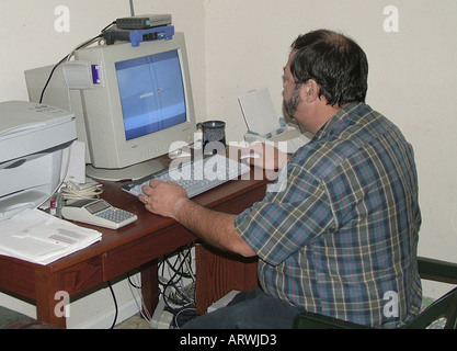 man working on desktop computer at home Stock Photo
