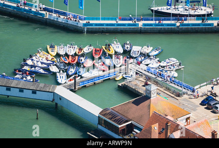 RHIBs (Rigid Hull Inflatable Boats) moored at Cowes quay while sailors go ashore during Skandia Cowes Week. Stock Photo