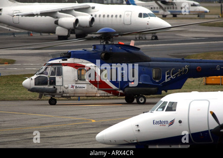 A Bristows Superpuma ec-225 helicopter taxis between aircraft at Aberdeen Airport, Scotland, UK Stock Photo