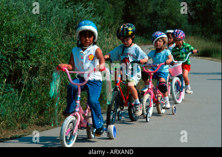 Group of young children cycling Steamboat Springs CO USA Stock Photo