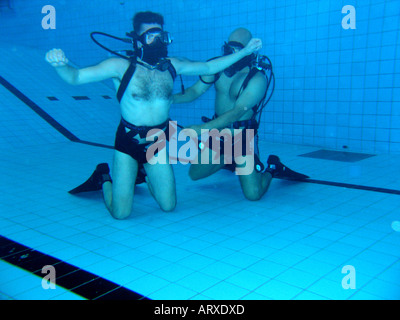 Practise underwater rescue in  swimmingpool Stock Photo