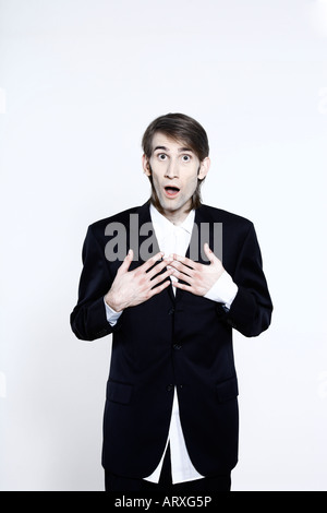 studio shot portrait of a young funny happy expressive thin and tall man on isolated background Stock Photo