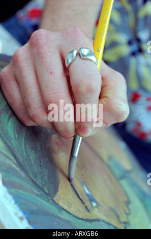 Close up of a student hand painting a portrait in an undergraduate college art class NYC Stock Photo