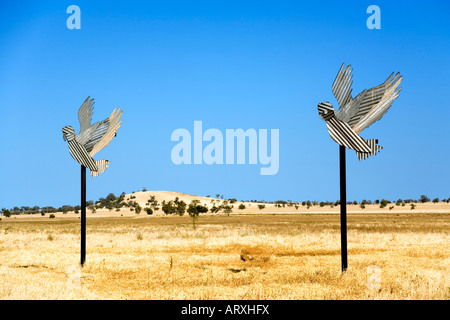 sculpture of a pair of corrugated iron cockatoos in outback Australia Stock Photo