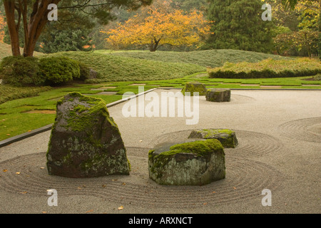 Japanese garden in Bloedel Reserve with Japanese maple  with fall colors visible in background Stock Photo