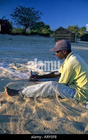 Fishermen mending their nets, Lake Malawi near Kande, Malawi Stock Photo
