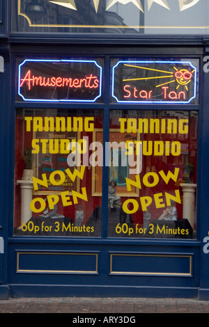 Shop window advertisements for tanning studio and amusements Stock Photo