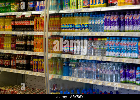 Bottled mineral water and fruit squash drinks for sale on a supermarket shelf Stock Photo