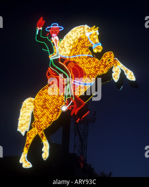 Neon Cowboy riding a horse on the old strip in downtown Las Vegas Nevada Stock Photo
