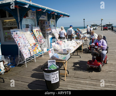 Senior citizens in motorised wheelchairs on pier Llandudno Wales UK Stock Photo