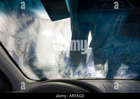 Car windscreen covered in soap suds inside automatic carwash Vancouver Canada Stock Photo