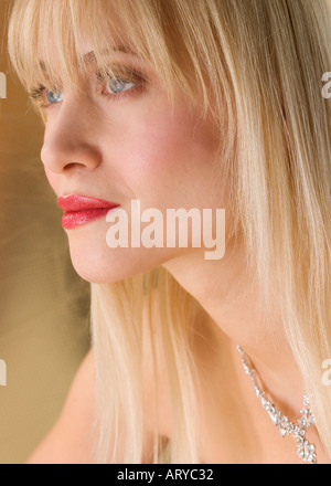 Profile of blond woman wearing necklace Stock Photo