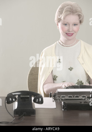 Woman at desk with typewriter Stock Photo