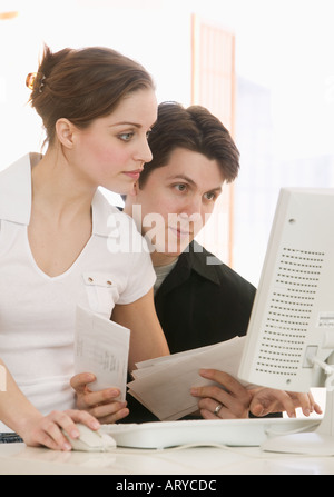 Young couple working at computer Stock Photo